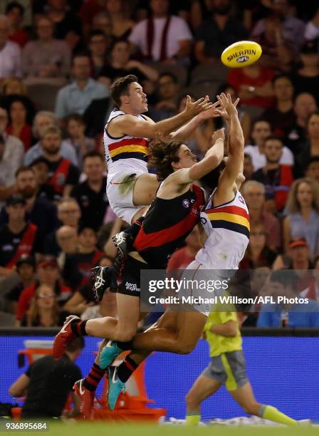 Mitch McGovern of the Crows, Michael Hartley of the Bombers and Darcy Fogarty of the Crows compete for the ball during the 2018 AFL round 01 match...