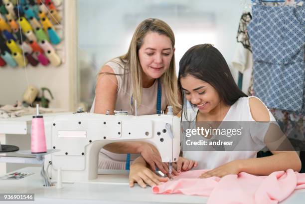 apprentice seamstress learning to sew at an atelier - atelier fashion stock pictures, royalty-free photos & images