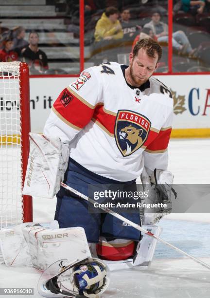 James Reimer of the Florida Panthers adjusts his mask after being hit in the face in a game against the Ottawa Senators at Canadian Tire Centre on...
