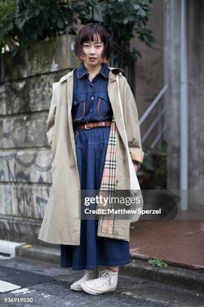 Guest is seen wearing a Burberry coat with denim jumpsuit during the Amazon Fashion Week TOKYO 2018 A/W on March 22, 2018 in Tokyo, Japan.