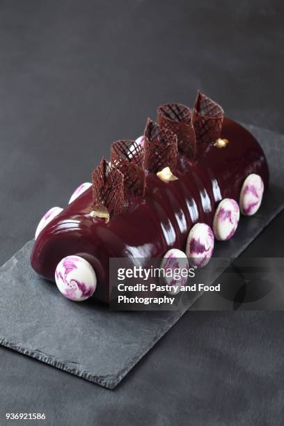 contemporary black currant chocolate yule log - christmas log stock pictures, royalty-free photos & images