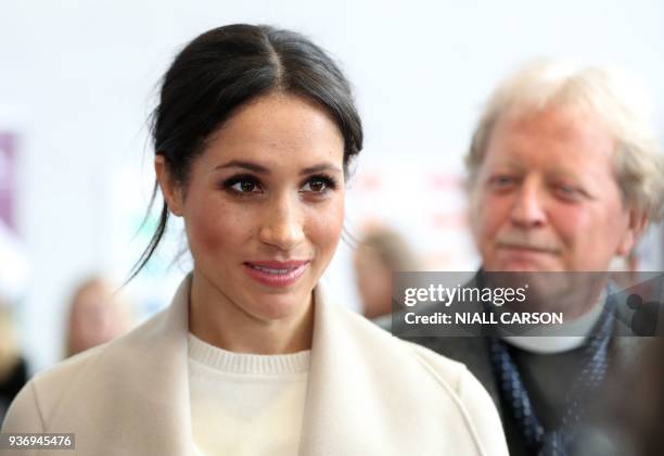 Actress and fiancee of Britain's Prince Harry Meghan Markle gestures during a visit at the Eikon Centre in Lisburn, on March 23 to attend an event to...