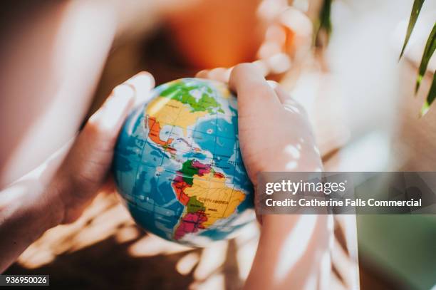 the whole world in his hands - travel agent stock pictures, royalty-free photos & images