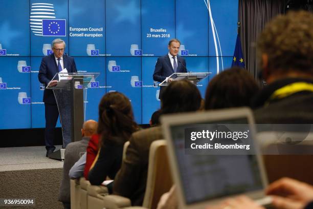 Jean-Claude Juncker, president of the European Commission, left, looks at notes as Donald Tusk, president of the European Union , speaks during a...