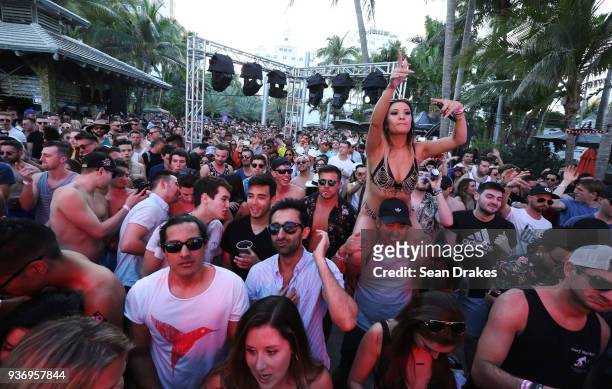 Guests dance to DJ music during the MK Area 10 Party hosted by 93.5FM Revolution Radio Miami at the National Hotel on South Beach as part of Miami...