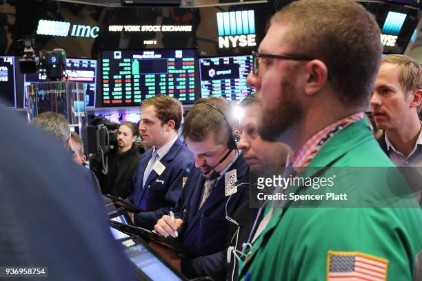 Traders work on the floor of the New York Stock Exchange on March 23, 2018 in New York City. Despite yesterday's massive loss due to trade war fears...