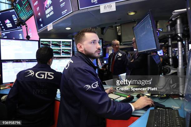 Traders work on the floor of the New York Stock Exchange on March 23, 2018 in New York City. Despite yesterday's massive loss due to trade war fears...