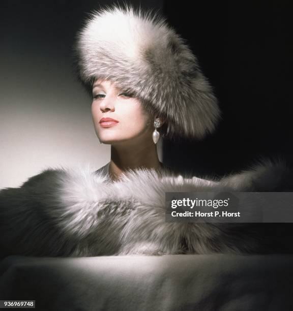 Model wearing an enormous pale grey fox beret and boa by Sally Victor.