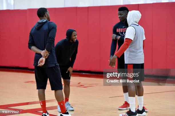 Markel Brown Clint Cappella James Harden and Chris Paul of the Houston Rockets talk during a Houston Rockets practice at Toyota Center in Houston,...