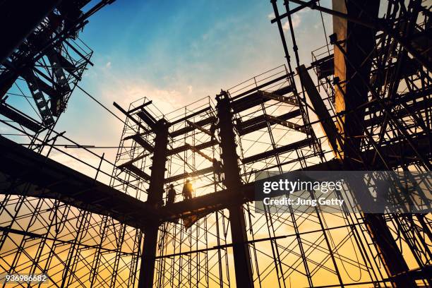 construction site on sunset background - scaffolding industrial stock pictures, royalty-free photos & images