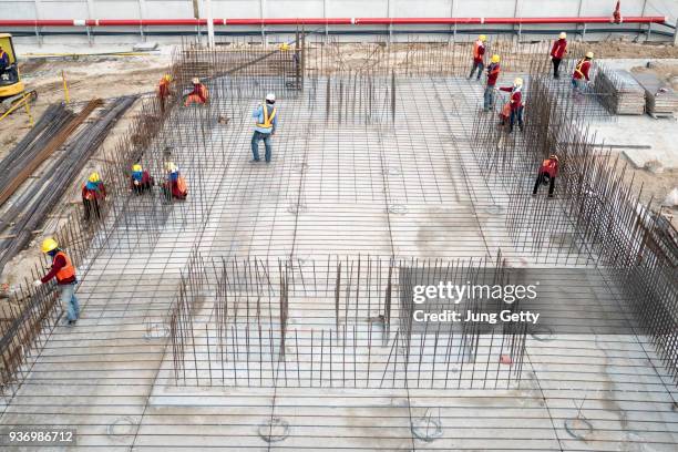 aerial view on construction building. construction site workers - aerial view construction workers stock-fotos und bilder