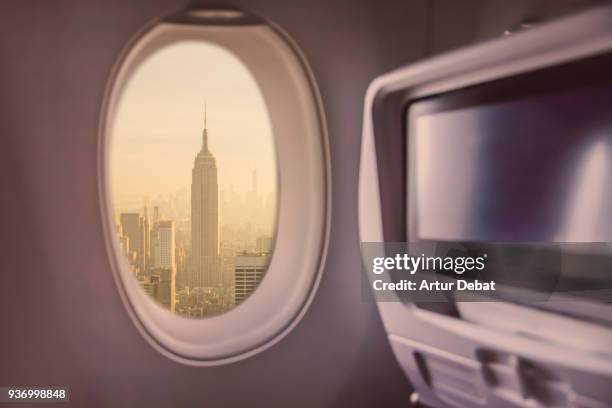 picture taken from airplane window traveling around the world from the airplane with manhattan skyline view. - window seat fotografías e imágenes de stock