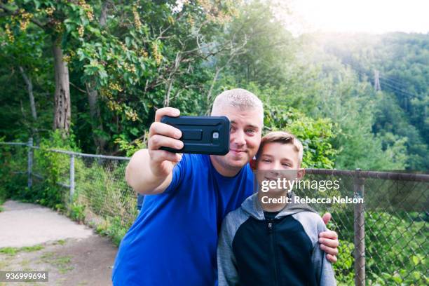 dad taking selfie with his 10 year old son - pisgah national forest stock pictures, royalty-free photos & images