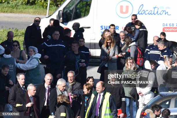 Paris prosecutor Francois Molins gestures as he speaks to French security and police outside the Super U supermarket in the town of Trebes, southern...