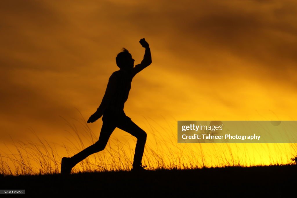 Silhouette of a cricket bowler