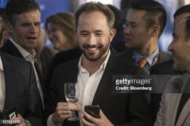 Drew Houston, chief executive officer and co-founder of Dropbox Inc., center, smiles during the company's initial public offering at the Nasdaq...