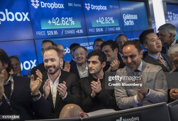 Drew Houston, chief executive officer and co-founder of Dropbox Inc., center left, and Arash Ferdowsi, co-founder of Dropbox Inc., center, applaud...