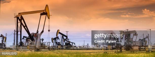 panoramic pumpjack lifts oil from a well in california - lost hills california stock pictures, royalty-free photos & images