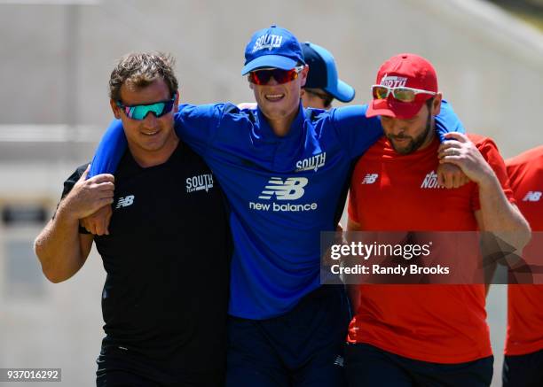 Nick Gubbins of South is helped off the field due to an injury during the ECB North v South Series match Three at 3Ws Oval on March 23, 2018 in...