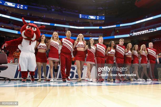 The Arkansas cheerleaders and mascot sing the school's alma mater at the conclusion of the NCAA Division I Men's Championship First Round basketball...