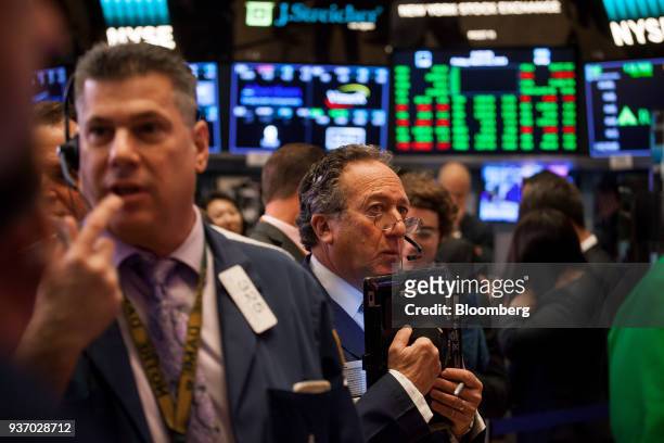 Traders work on the floor of the New York Stock Exchange in New York, U.S., on Friday, March 23, 2018. U.S. Stocks turned lower in what's shaping up...