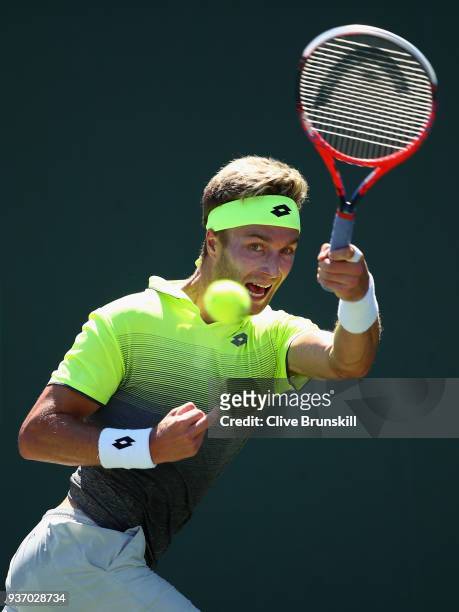 Liam Broady of Great Britain plays a forehand against Filip Krajinovic of Serbia in their second round match during the Miami Open Presented by Itau...