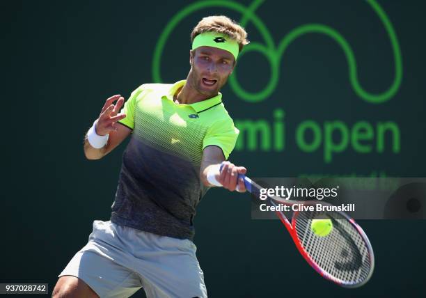 Liam Broady of Great Britain plays a forehand against Filip Krajinovic of Serbia in their second round match during the Miami Open Presented by Itau...