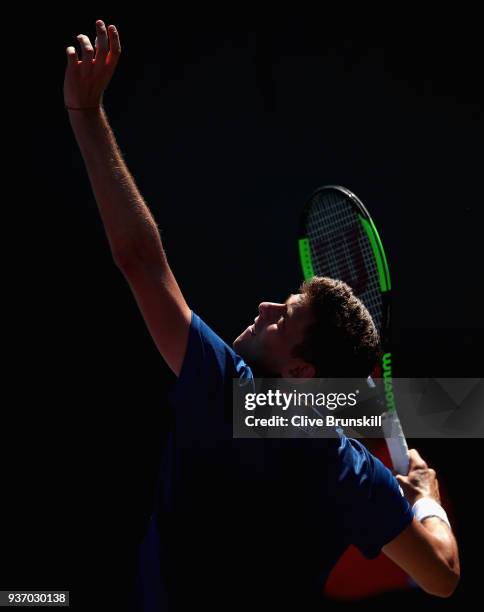 Filip Krajinovic of Serbia serves against Liam Broady of Great Britain in their second round match during the Miami Open Presented by Itau at Crandon...