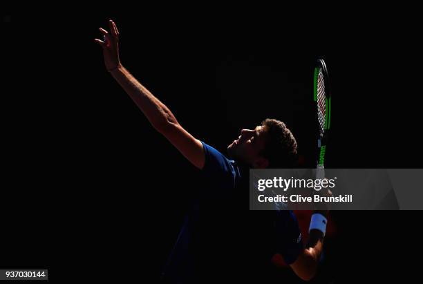 Filip Krajinovic of Serbia serves against Liam Broady of Great Britain in their second round match during the Miami Open Presented by Itau at Crandon...