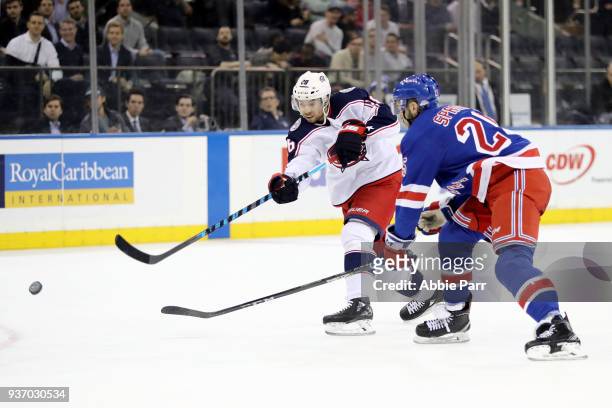 Oliver Bjorkstrand of the Columbus Blue Jackets passes the puck against Ryan Sproul of the New York Rangers in the third period during their game at...