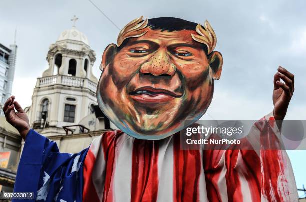 Protester spreads his arms as he march from Plaza Miranda to Mendiola Peace Arch on March 23, 2018. Groups of activists hold a lent-themed...