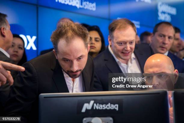 Dropbox CEO Drew Houston monitors computer screens as trading starts on Dropbox's initial public offering at Nasdaq MarketSite, March 23, 2018 in New...