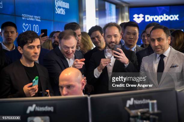 Dropbox CEO Drew Houston takes a photo as trading starts on Dropbox's initial public offering at Nasdaq MarketSite, March 23, 2018 in New York City....