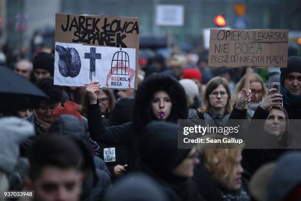 People protesting against a new government measure to further restrict abortions in Poland march as part of "Black Friday" demonstrations nationwide...