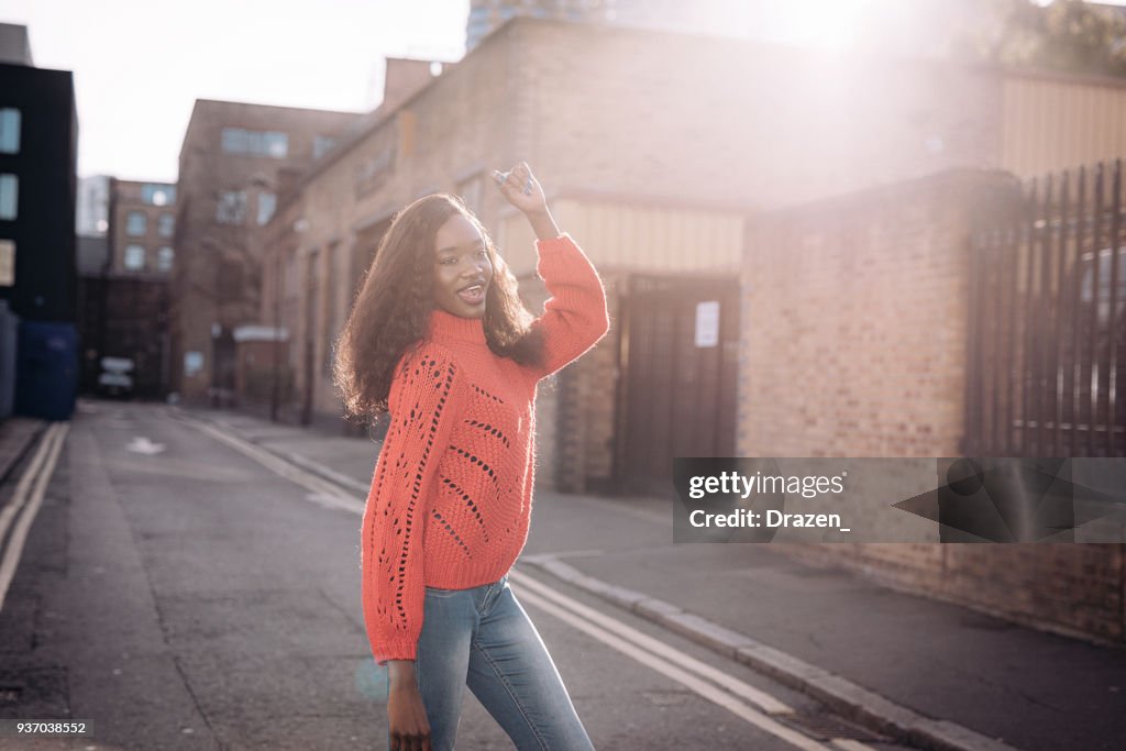 Portrait of Central African woman smiling and raising her arms