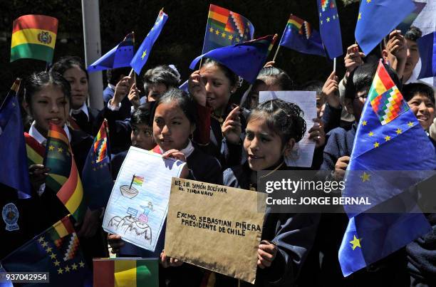 Pupils of the Simon Bolivar school wave so-called "flags of maritime revindication" as they arrive at the Chilean consulate in La Paz on March 23,...