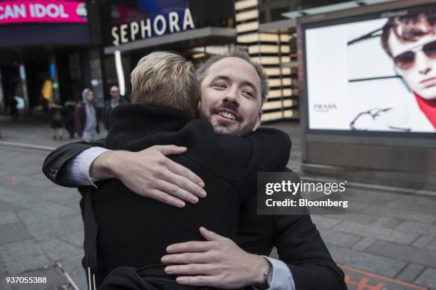 Drew Houston, chief executive officer and co-founder of Dropbox Inc., hugs a friend outside the Nasdaq MarketSite during the company's initial public...