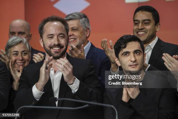 Drew Houston, chief executive officer and co-founder of Dropbox Inc., left, and Arash Ferdowsi, co-founder of Dropbox Inc., applaud during the...