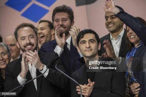 Drew Houston, chief executive officer and co-founder of Dropbox Inc., left, and Arash Ferdowsi, co-founder of Dropbox Inc., applaud during the...