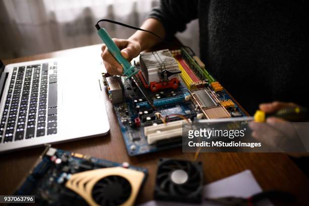 close up of a woman hands repairing computer. - repairing stock pictures, royalty-free photos & images