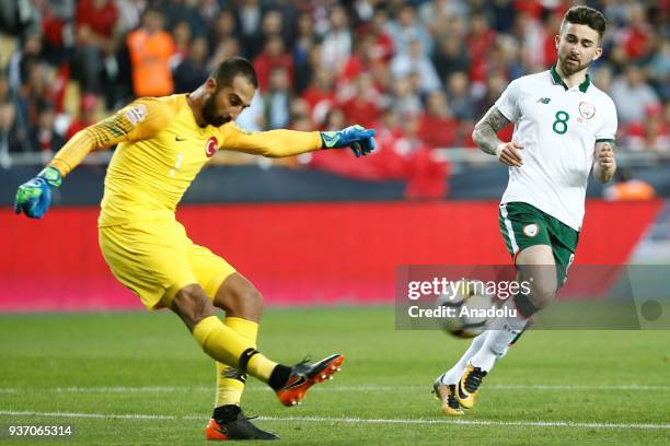 Goal keeper Volkan Babacan of Turkey kicks the ball as Sean Maguire of Sweden stands near him during a friendly football match between Turkey and...