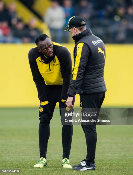 Usain Bolt together with Peter Stoeger, head coach of Borussia Dortmund, during the training session at the training ground on March 23, 2018 in...