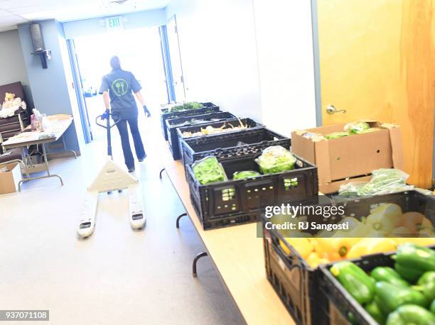 Rani Piece, an employee at We Don't Waste, leaves after delivering food at a church food bank in Federal Heights on March 23, 2018 in Denver,...