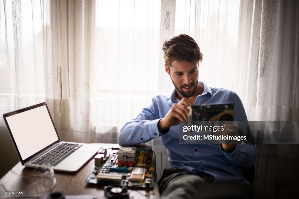 Man fixing computer.