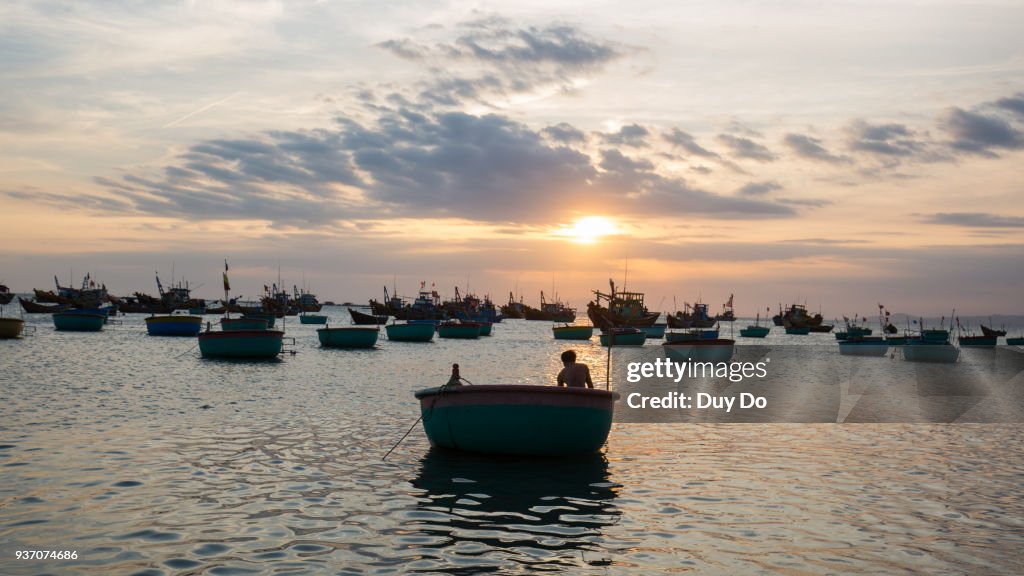 Silhouette landscape of floating fishing boat in Mui Ne village during sunset, Phan Thiet, Vietnam