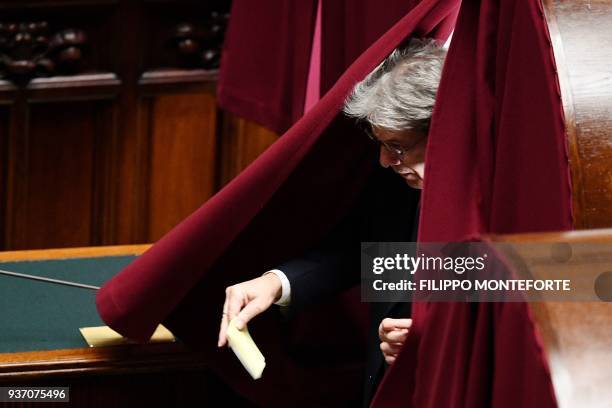 Italy's Prime Minister Paolo Gentiloni leaves a polling booth at the Chamber of Deputies during the first session, in Rome on March 23, 2018...