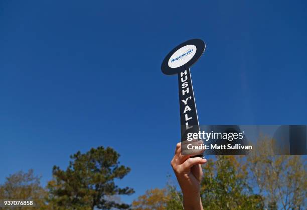 Volunteer holds a sign up to the gallery during the first round of the Rapiscan Systems Classic at Fallen Oak Golf Course on March 23, 2018 in...