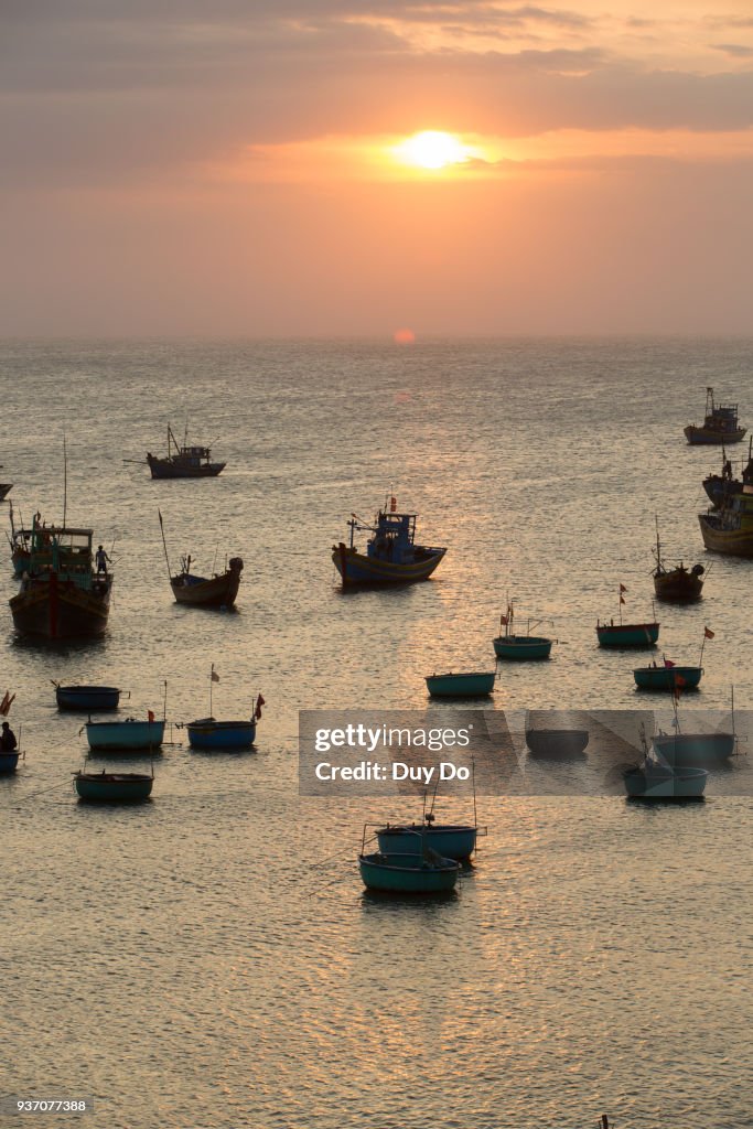 Silhouette landscape of floating fishing boat in Mui Ne village during sunset, Phan Thiet, Vietnam