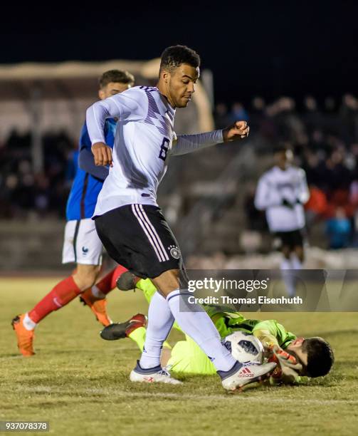 Jean-Manuel Mbom of Germany and goalkeeper Illan Meslier of France vie for the ball during the U18 international friendly match between Germany and...