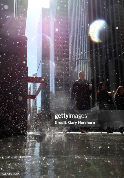 Melting snow falls to the sidewalk on 6th Avenue the day after a nor'easter storm hit the city on March 22, 2018 in New York City.